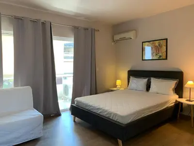 a bedroom with a bed and a window at Rivi Apartments in Athens