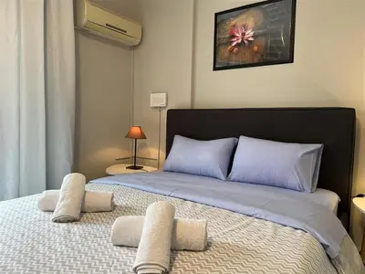 a bedroom with a large bed with two pillows at Rivi Apartments in Athens