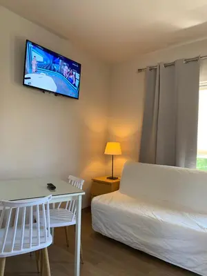 a bedroom with a bed and a tv on the wall at Rivi Apartments in Athens