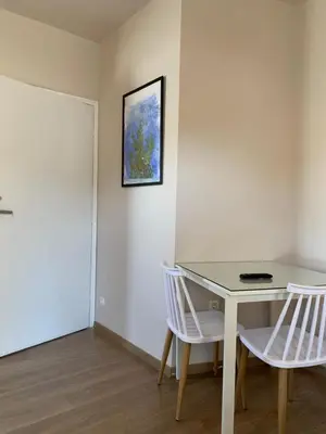a room with a table and two white chairs at Rivi Apartments in Athens