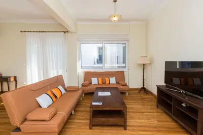 a living room with a couch and a coffee table at Luxury Apartments at the foot of the Acropolis Hill in Athens