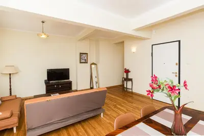 a living room with a couch and a tv at Luxury Apartments at the foot of the Acropolis Hill in Athens