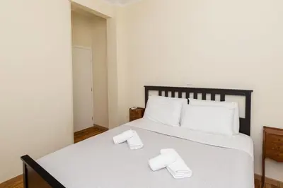 a bedroom with a bed with two slippers on it at Luxury Apartments at the foot of the Acropolis Hill in Athens