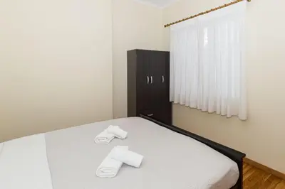 a bedroom with a bed with slippers on it at Luxury Apartments at the foot of the Acropolis Hill in Athens