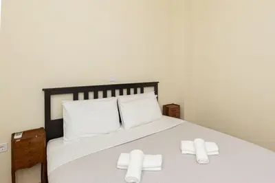 a bedroom with a bed with two white towels on it at Luxury Apartments at the foot of the Acropolis Hill in Athens