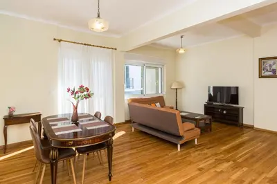 a living room with a table and a couch at Luxury Apartments at the foot of the Acropolis Hill in Athens