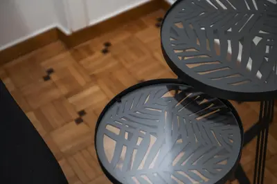 two black tables sitting on top of a wooden floor at Oculus 2BD Athens Central Escape by Live&Travel in Athens
