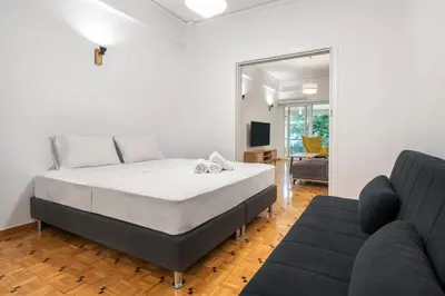 a bedroom with a bed and a couch at Oculus 2BD Athens Central Escape by Live&Travel in Athens