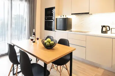 a kitchen with a table with a bowl of fruit on it at Aellō luxury apartments in Markopoulo