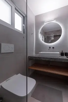 a bathroom with a toilet and a sink and a mirror at Athens-Riviera apartment in front the sea Voula in Athens