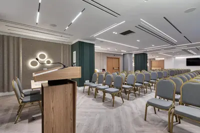 a room with rows of chairs and a podium at Hilton Garden Inn Athens Syggrou Avenue in Athens