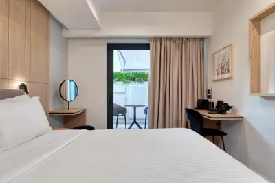 a hotel room with a large bed and a desk at Hilton Garden Inn Athens Syggrou Avenue in Athens