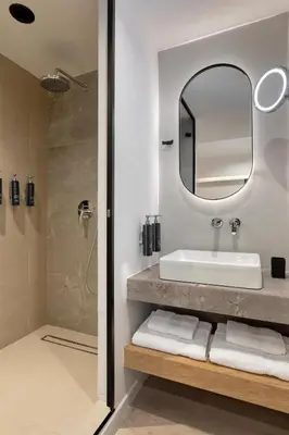 a bathroom with a sink and a mirror at Hilton Garden Inn Athens Syggrou Avenue in Athens