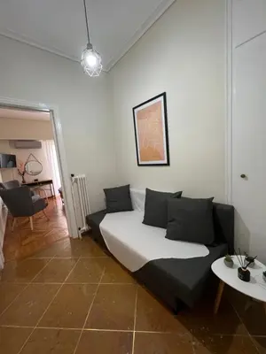 a living room with a couch and a table at Apartment in Athens in Athens