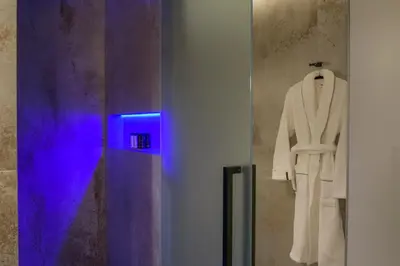 a white suit is hanging on a wall at AVAL Riviera in Lagonissi