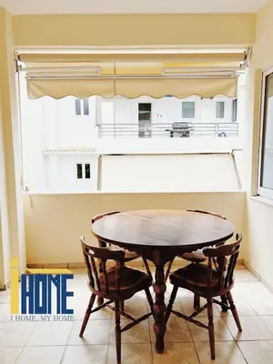 a table and two chairs in a room with a window at Ammo Glyfada Residences in Athens