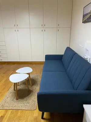 a blue couch and a table in a room at Ammo Glyfada Residences in Athens