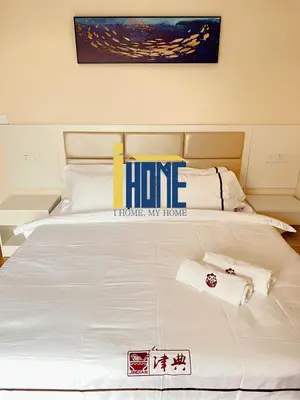 a large white bed with two towels on it at Ammo Glyfada Residences in Athens