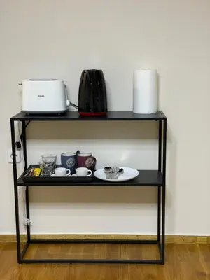 a black shelf with a plate and appliances on it at Ammo Glyfada Residences in Athens