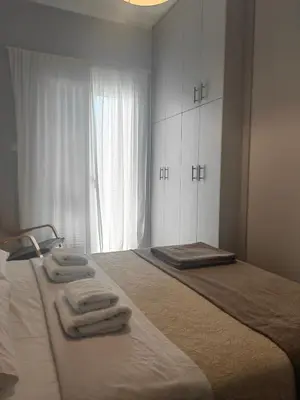 a bedroom with a large bed with towels on it at Hermes - Acropolis Residence Apartment in Athens