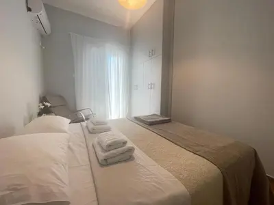 a bedroom with two beds with towels on them at Hermes - Acropolis Residence Apartment in Athens