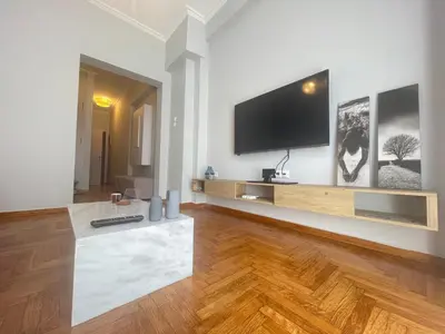 a living room with a flat screen tv on a wall at Hermes - Acropolis Residence Apartment in Athens