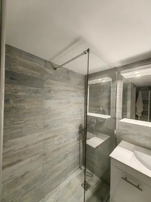 a bathroom with a shower and a sink and a mirror at Hermes - Acropolis Residence Apartment in Athens