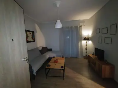 a living room with a couch and a coffee table at Nice& Cozy Flat 1min from the Heart of Athens.WiFi in Athens