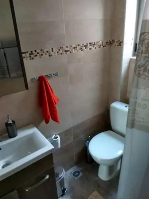 a bathroom with a white toilet and a sink at Nice& Cozy Flat 1min from the Heart of Athens.WiFi in Athens
