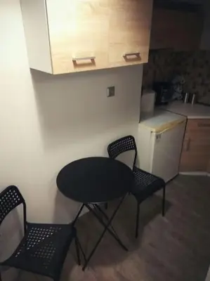 a table and two chairs in a small kitchen at Nice& Cozy Flat 1min from the Heart of Athens.WiFi in Athens