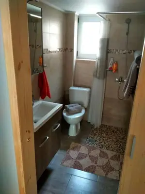 a bathroom with a toilet and a sink and a shower at Nice& Cozy Flat 1min from the Heart of Athens.WiFi in Athens