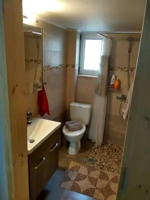 a bathroom with a toilet and a sink and a shower at Nice& Cozy Flat 1min from the Heart of Athens.WiFi in Athens