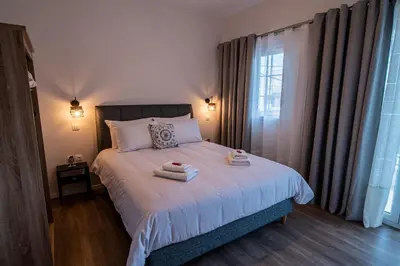 a bedroom with a bed with two towels on it at Andromeda apartments in Spáta