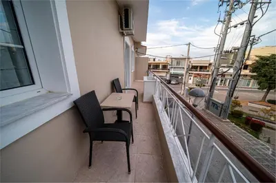 a balcony with two chairs and a table on a building at Andromeda apartments in Spáta