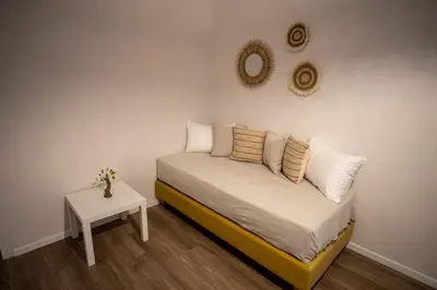 a small bedroom with a bed and a table at Andromeda apartments in Spáta