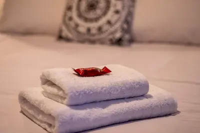 a pile of towels sitting on top of a bed at Andromeda apartments in Spáta