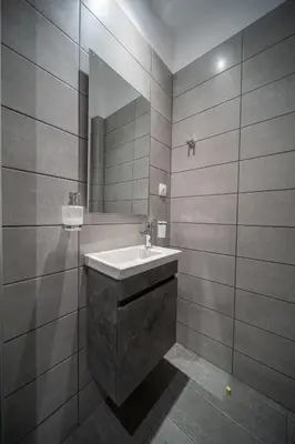 a bathroom with a sink and a mirror at Andromeda apartments in Spáta