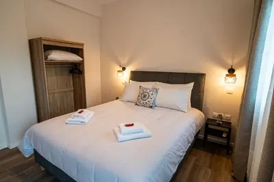 a bedroom with a bed with two towels on it at Andromeda apartments in Spáta