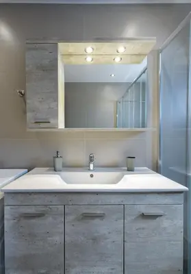 a bathroom with a sink and a mirror at Stylish 2BR flat with stunning views & prv parking in Athens