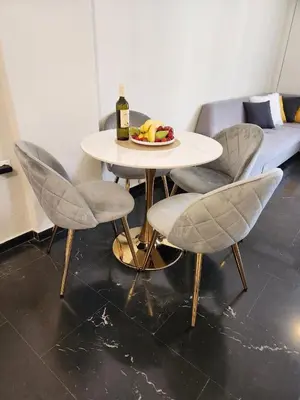 a table with two chairs and a bottle of wine at Acropolis Suite greendom in Athens