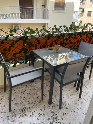 a table and two chairs on a patio at Acropolis Suite greendom in Athens