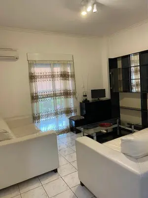 a living room with a couch and a table at Kalamaki Apartments in Athens