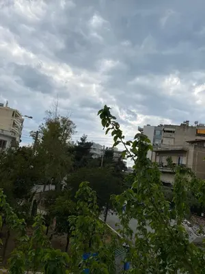 a view of a city with buildings and trees at Kalamaki Apartments in Athens