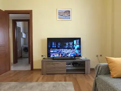 a living room with a flat screen tv on a table at Bright 3bed 3bath 10 min walk Acropolis in Athens