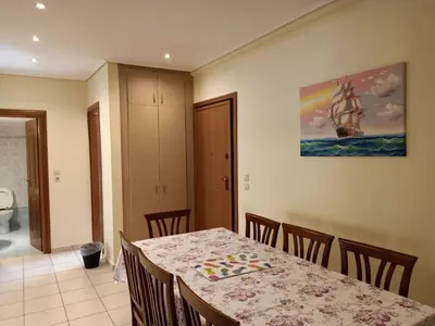 a dining room with a table and a ship on the wall at Bright 3bed 3bath 10 min walk Acropolis in Athens