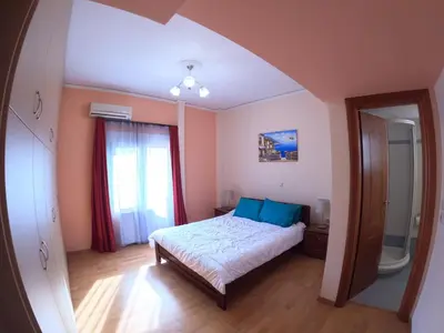 a bedroom with a bed and a large window at Bright 3bed 3bath 10 min walk Acropolis in Athens