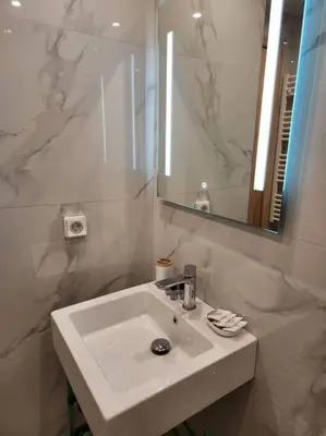 a white bathroom with a sink and a mirror at Lux House Attiki VIPGreece in Athens