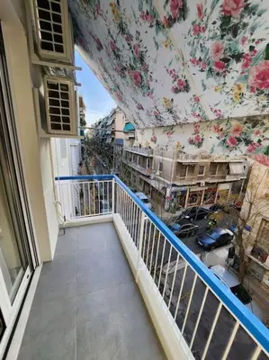 a balcony of a building with a floral wall at Lux House Attiki VIPGreece in Athens