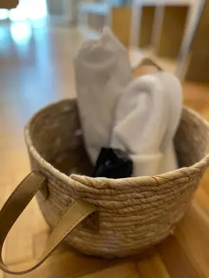 a basket filled with white items on a table at Christina-Anna Athens City Center walking distance to everywhere and Acropolis, in One of the most Favorable Locations by National Gardens and Zoo, Hellenic Parliament in Syntagma and Stylish Exquisite Kolonaki Cozy Renovated Apartment in Athens