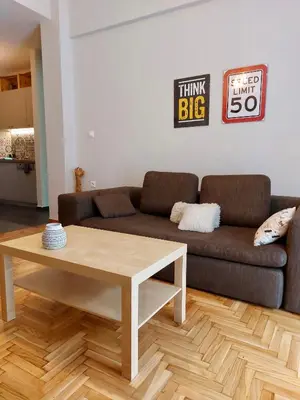 a living room with a couch and a coffee table at Christina-Anna Athens City Center walking distance to everywhere and Acropolis, in One of the most Favorable Locations by National Gardens and Zoo, Hellenic Parliament in Syntagma and Stylish Exquisite Kolonaki Cozy Renovated Apartment in Athens
